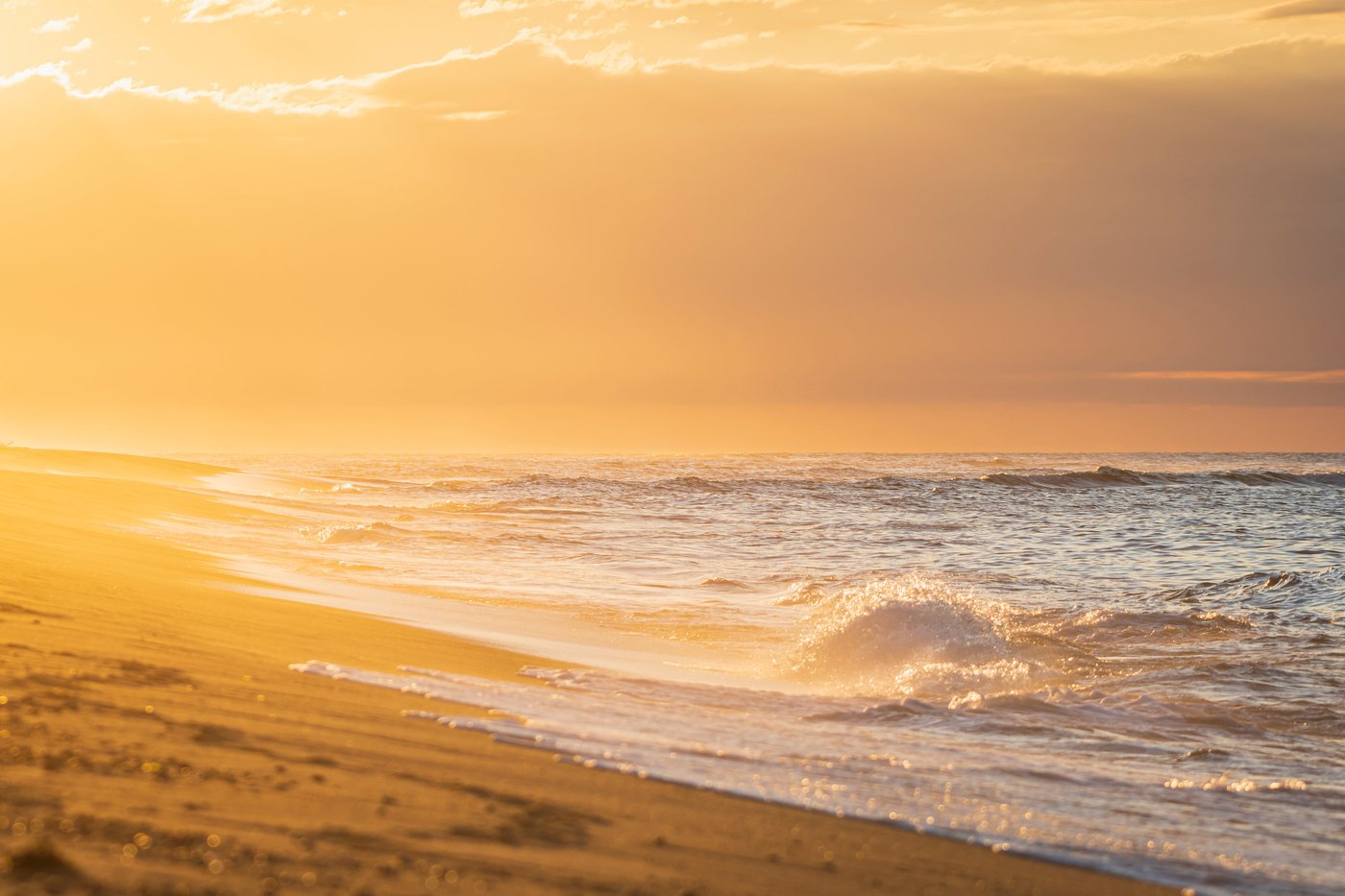 sunset-creates-orange-hue-along-the-beach