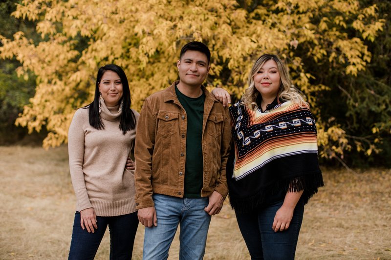 three-people-outside-posing-for-the-camera